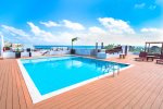 The Casa del Mar community rooftop with pool, oceanview, beds, and lounge chairs